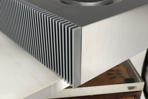 Rear left corner of a used Naim Mu-so GEN2 Wireless Music System in a silver finish