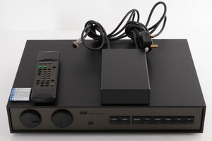 Top of a used Naim NAC102 W/ NAPSC in a Black finish showing Remote and Batteries