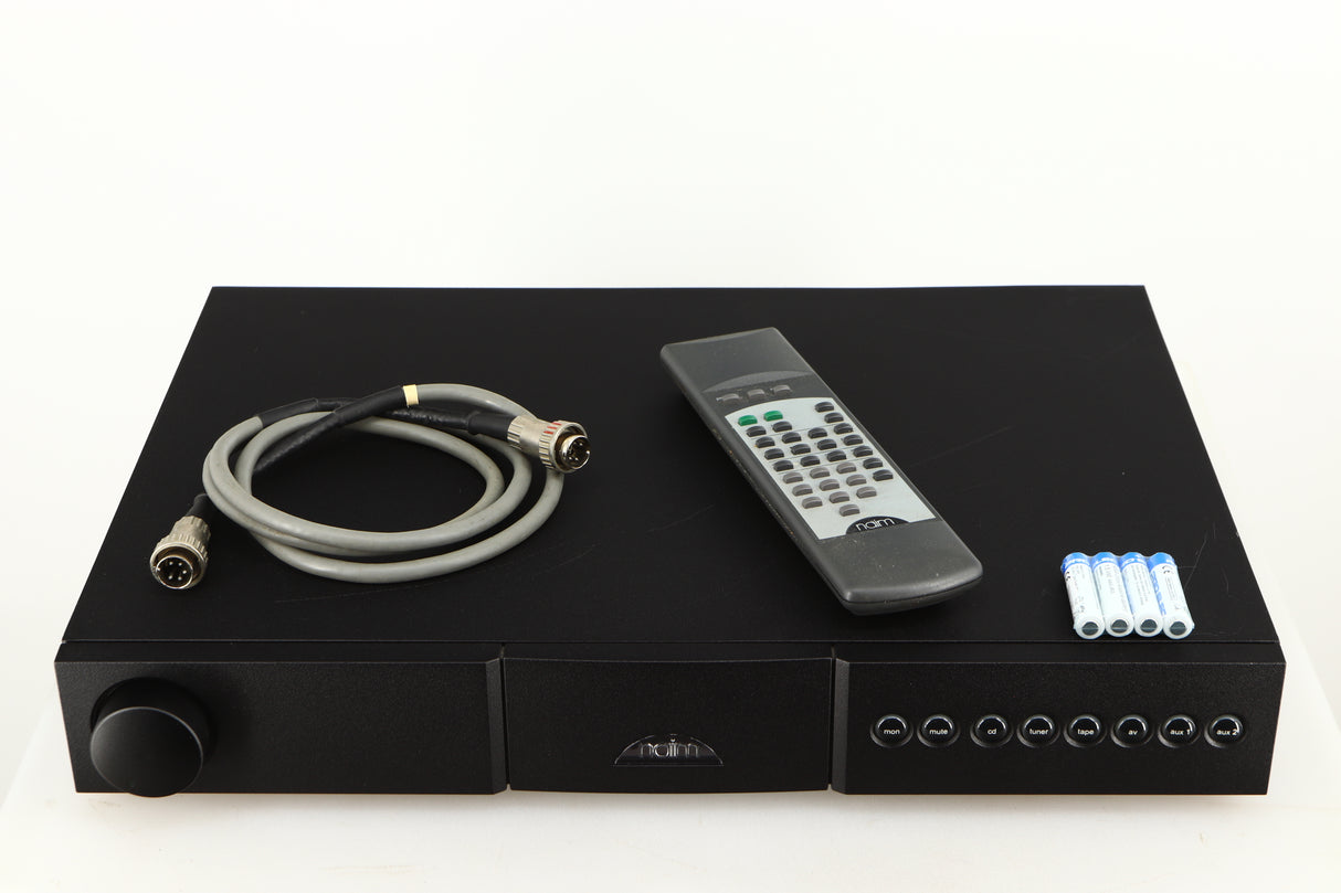 Top of a used Naim NAC112 Pre Amplifier in a black finish showing Remote, 4x Batteries and SNAIC5