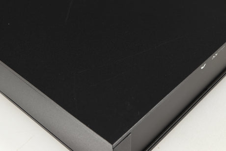 Close up of a used Naim NAC112 Pre Amplifier in a black finish showing scratching on top