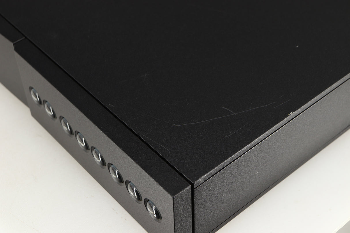 Close up of a used Naim NAC112 Pre Amplifier in a black finish showing scratching on top