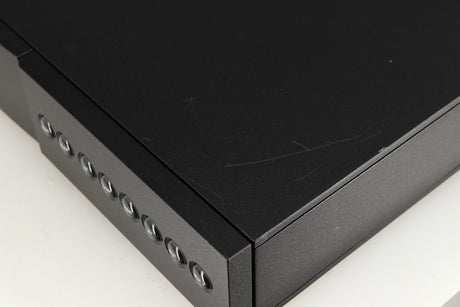 Close up of a used Naim NAC112 Pre Amplifier in a black finish showing scratching on top