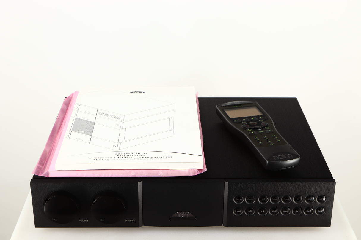 Top of a used Naim NAC552 Pre Amplifier in a black finish showing 2x Manuals and Remote
