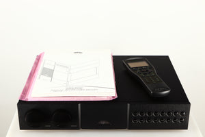 Top of a used Naim NAC552 Pre Amplifier in a black finish showing 2x Manuals and Remote
