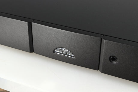 Close up of a used Naim NAIT 5si Integrated Amplifier in a black finish showing the logo