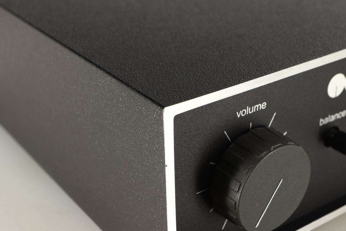 Close up of a used Naim NAIT Integrated Amplifier in a black finish showing blemish on front left corner