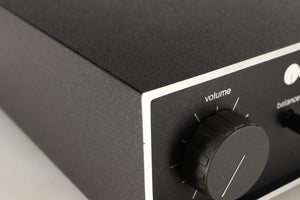 Close up of a used Naim NAIT Integrated Amplifier in a black finish showing blemish on front left corner
