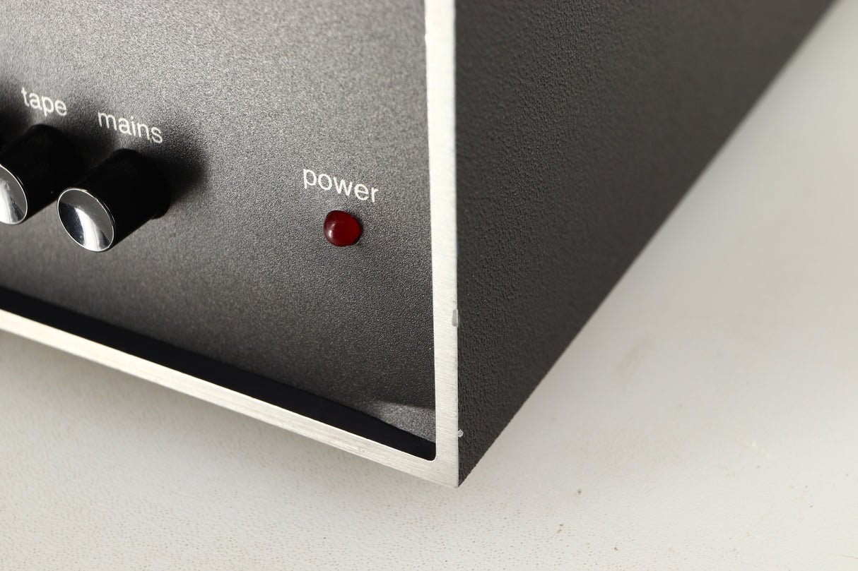 Close up of a used Naim NAIT Integrated Amplifier in a black finish showing blemish on front right corner and fascia