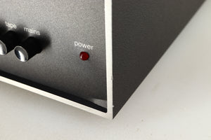 Close up of a used Naim NAIT Integrated Amplifier in a black finish showing blemish on front right corner and fascia