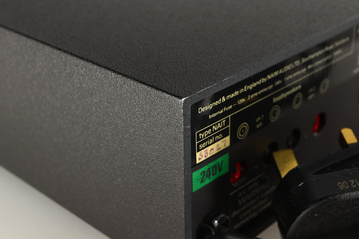 Close up of a used Naim NAIT Integrated Amplifier in a black finish showing blemish on rear right corner