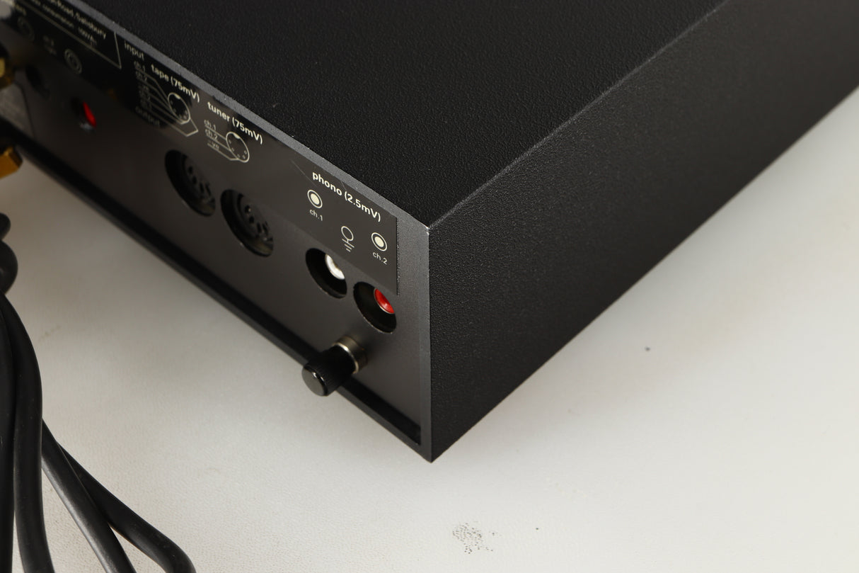 Rear left corner of a used Naim NAIT Integrated Amplifier in a black finish