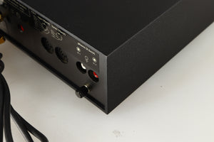 Rear left corner of a used Naim NAIT Integrated Amplifier in a black finish
