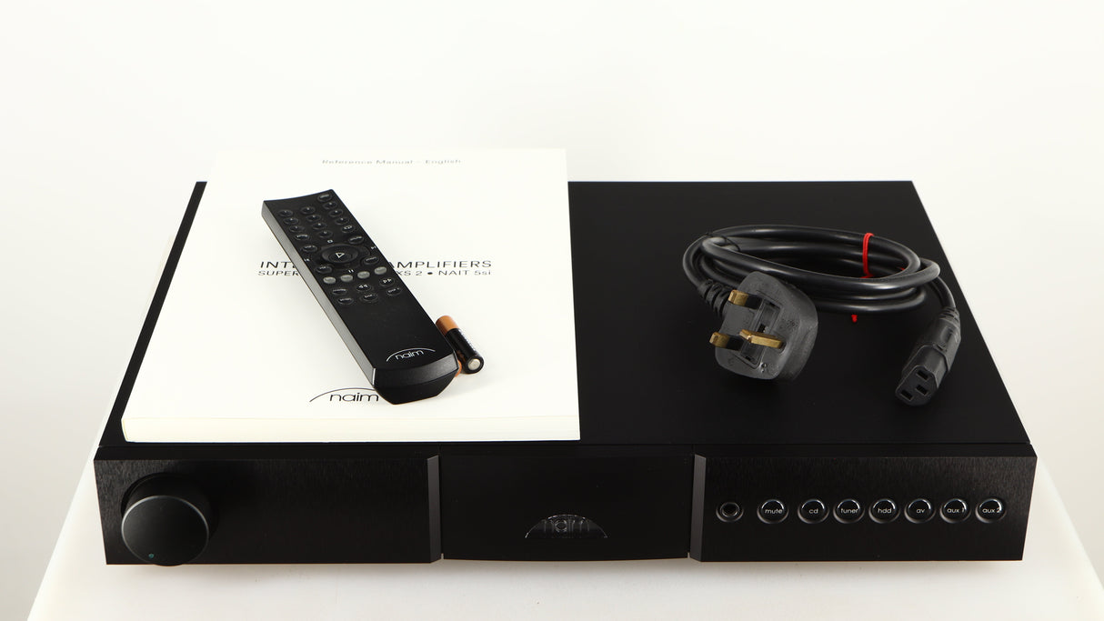 Top of a used Naim Nait XS-2 Integrated Amplifier in a black finish showing Mains Cable, Remote, Manual and 2x Batteries