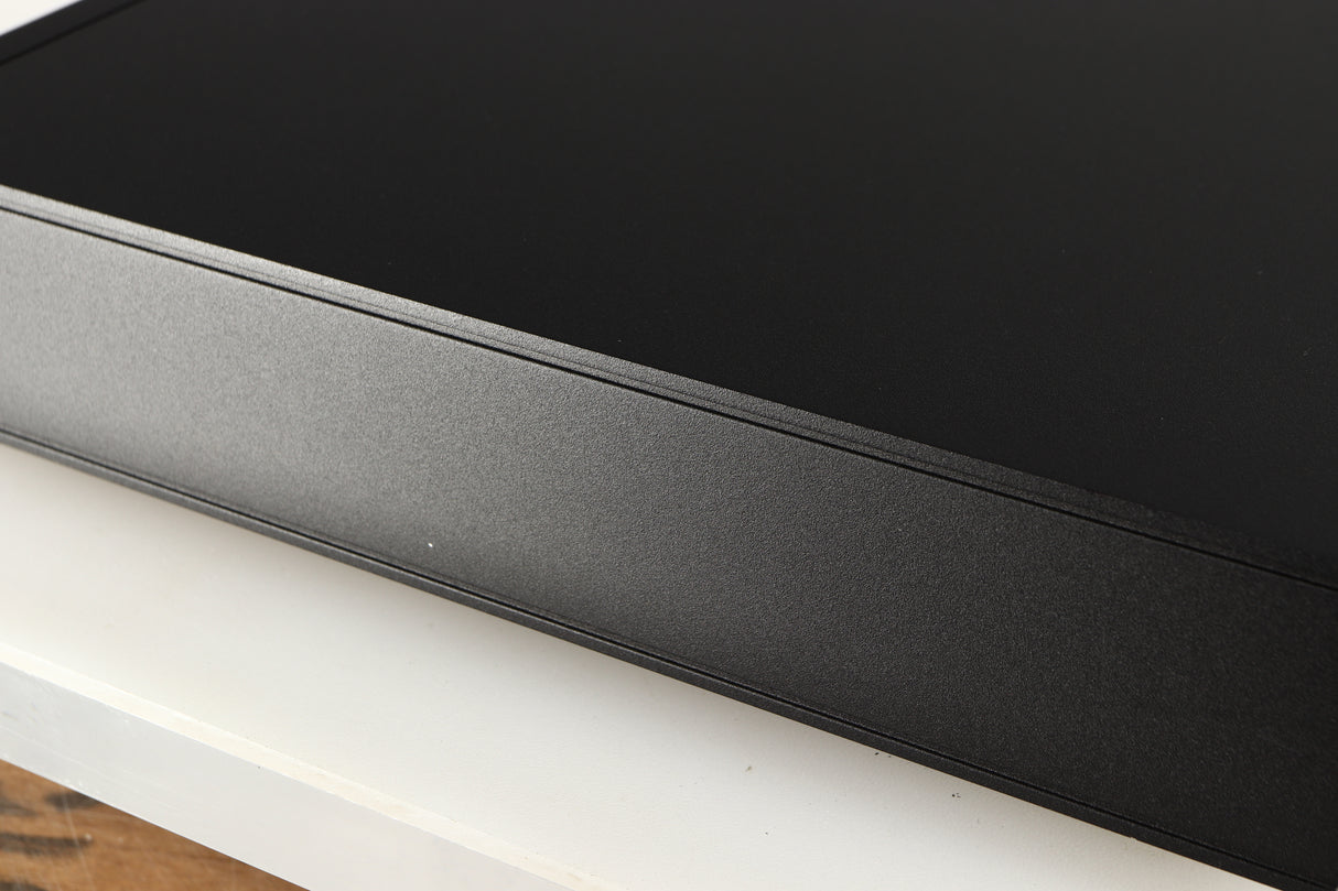 Close up of a used Naim Nait XS-2 Integrated Amplifier in a black finish showing small nick and light scratch on right side