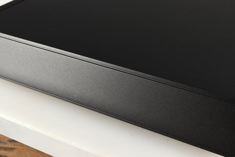 Close up of a used Naim Nait XS-2 Integrated Amplifier in a black finish showing small nick and light scratch on right side