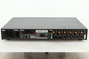 Rear view of a used Naim Nait XS-2 Integrated Amplifier showing mains input, speaker outputs, RCA, and SNAIC inputs 