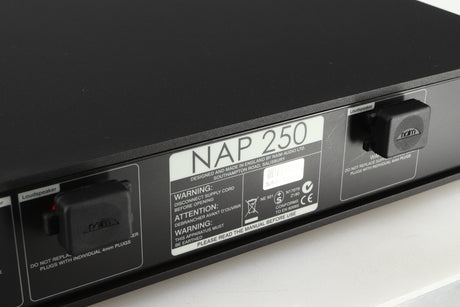 Close up of a used Naim NAP 250 Power Amplifier in a black finish showing scratches on the rear