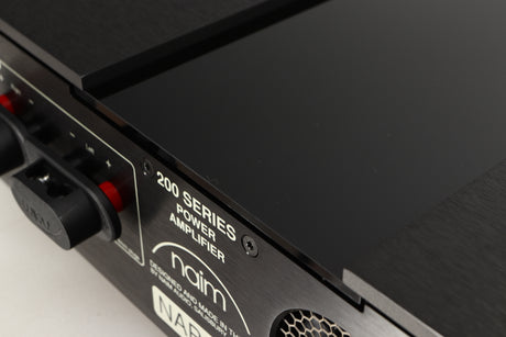 Close up of a used Naim NAP 250 Power Amplifier in a black finish showing scratch on rear