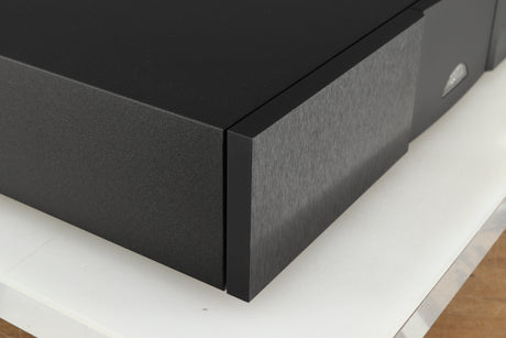 Front left corner of a used Naim NAP 250 Power Amplifier in a black finish