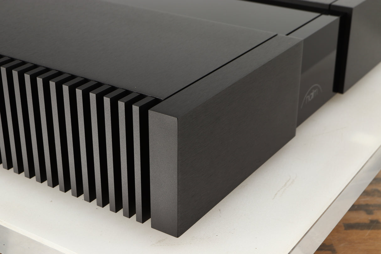 Front left corner of a used Naim NAP 250 Power Amplifier in a black finish