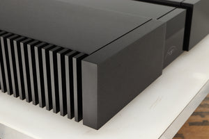 Front left corner of a used Naim NAP 250 Power Amplifier in a black finish