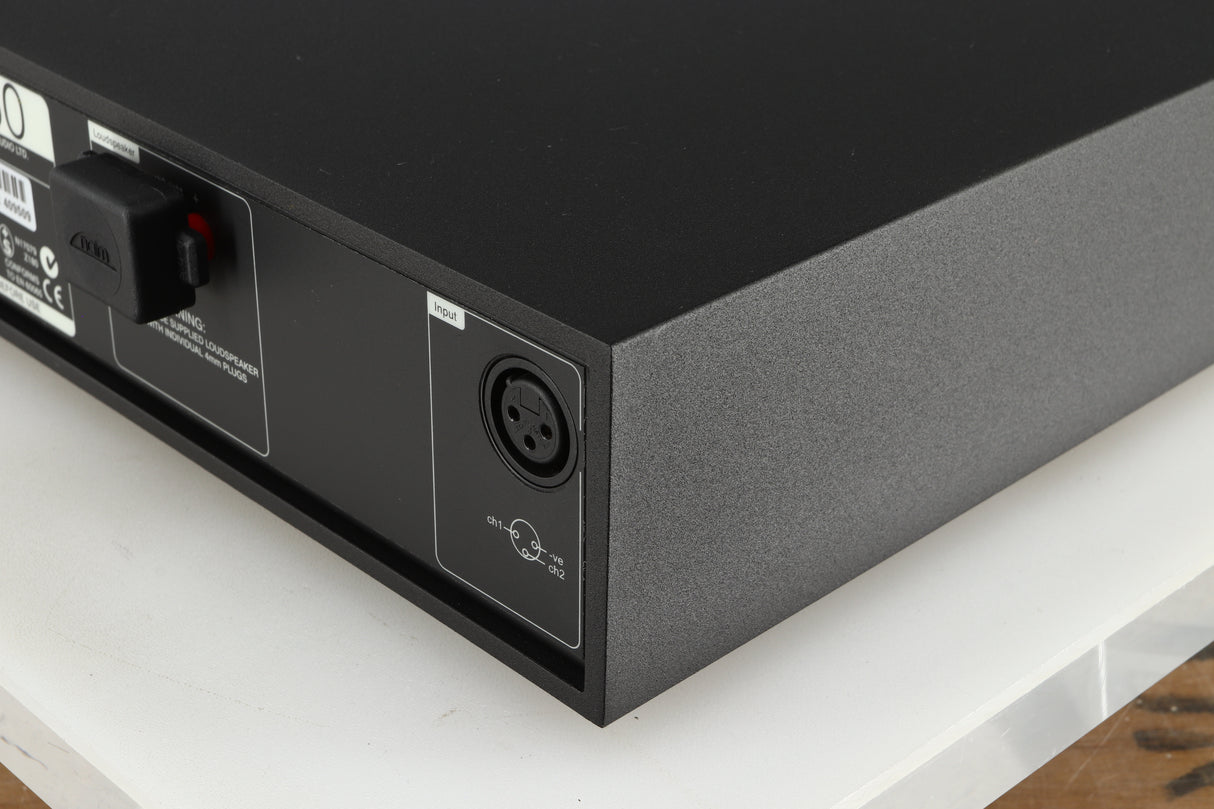 Rear left corner of a used Naim NAP 250 Power Amplifier in a black finish
