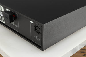 Rear left corner of a used Naim NAP 250 Power Amplifier in a black finish