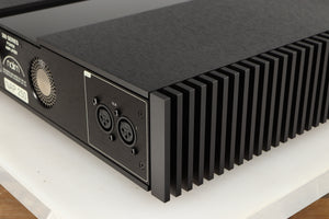 Rear left corner of a used Naim NAP 250 Power Amplifier in a black finish
