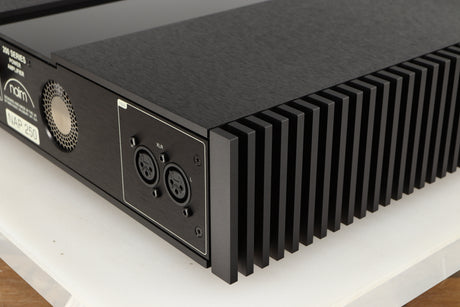 Rear left corner of a used Naim NAP 250 Power Amplifier in a black finish
