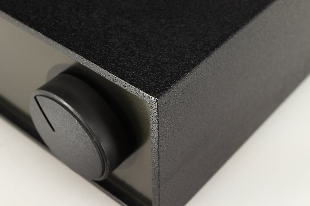 Close up of a used Naim NAP140 Power Amplifier in a black finish showing tiny blemish on front right corner