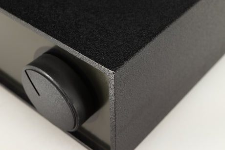 Close up of a used Naim NAP140 Power Amplifier in a black finish showing tiny blemish on front right corner