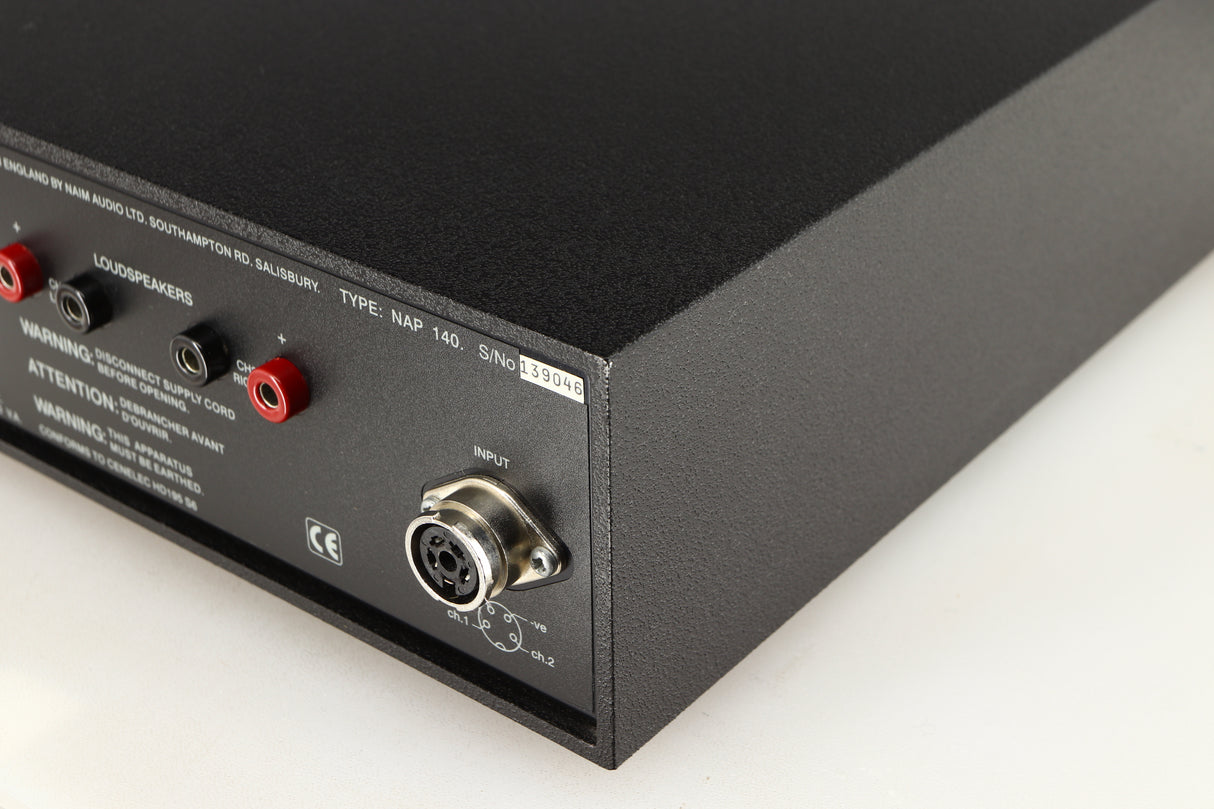 Rear left corner of a used Naim NAP140 Power Amplifier in a black finish