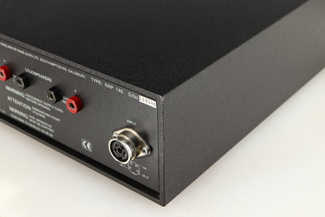 Rear left corner of a used Naim NAP140 Power Amplifier in a black finish