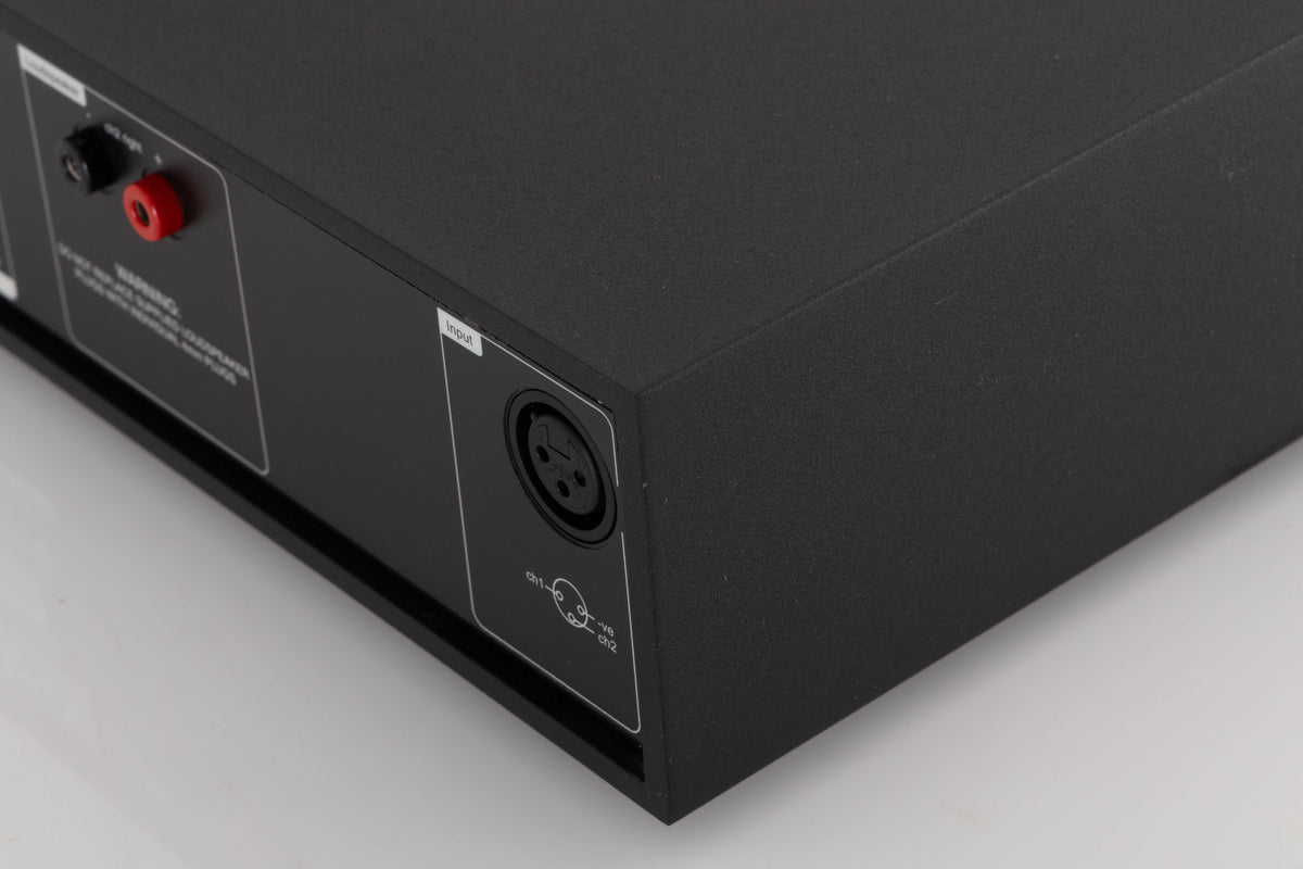 Rear left corner of a used Naim NAP250-2 Power Amplifier in a Black finish