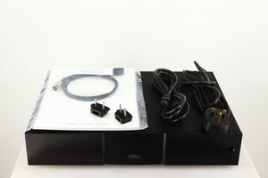 Top of a used Naim NAP250 DR Power Amplifier in a black finish  showing Manual, SNAIC4, 2x Link Plugs, Mains Cable and Schuko Cable