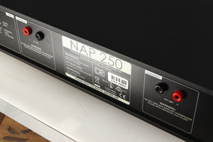 Close up of a used Naim NAP250 DR Power Amplifier in a black finish showing scratching on rear