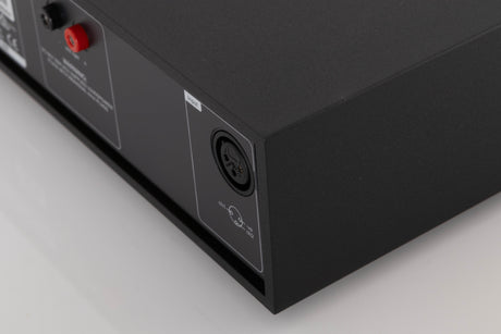 Rear left corner of a used Naim NAP250 DR Power Amplifier in a Black finish