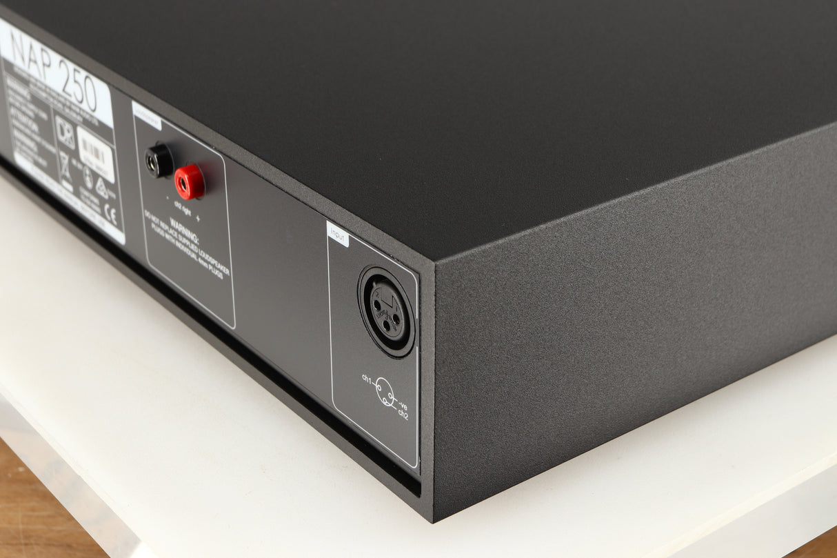 Rear left corner of a used Naim NAP250 DR Power Amplifier in a black finish 