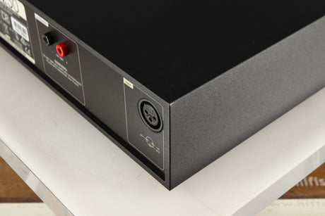 Rear left corner of a used Naim NAP250 DR Power Amplifier in a black finish