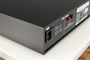 Rear right corner of a used Naim NAP250 DR Power Amplifier in a black finish 