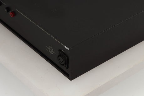 Rear left corner of a used Naim NAP250 Power Amplifier in a black finish
