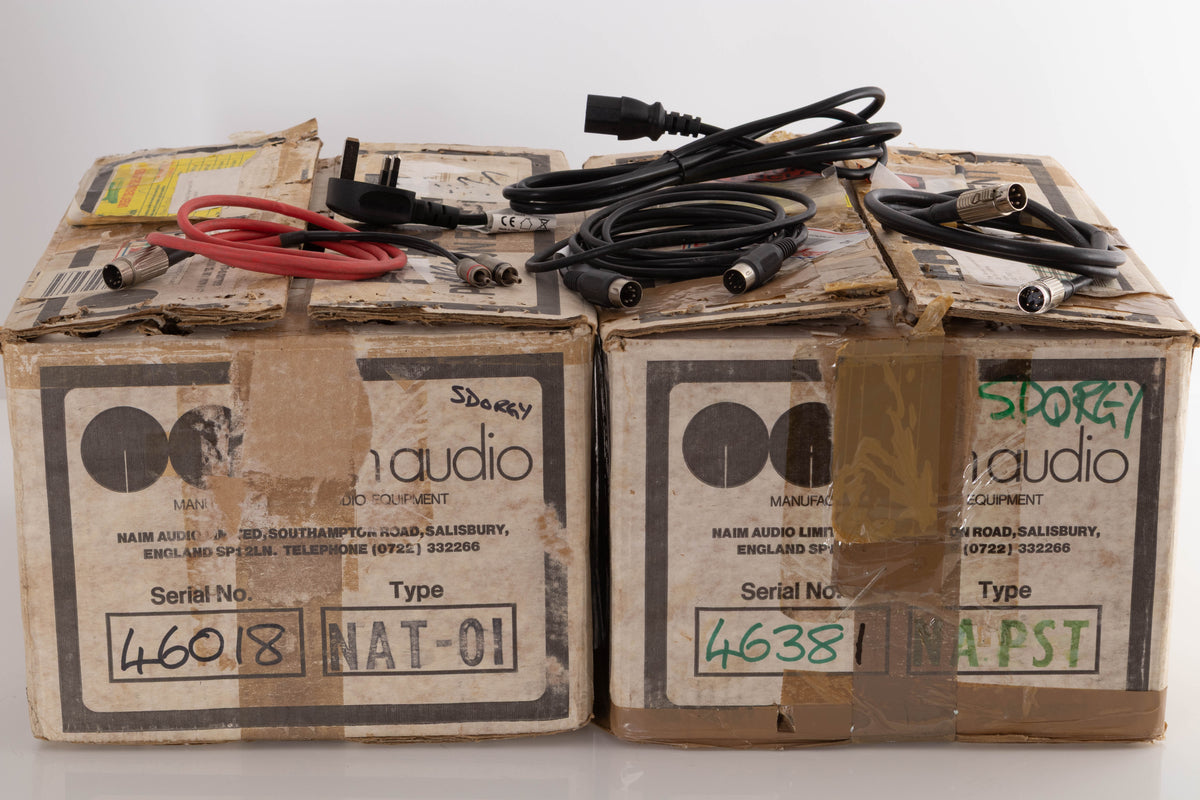 Boxes of a used Naim NAT 01 Tuner and NAPST Power Supply with Mains Cable, 4-Pin SNAIC, 5-Pin SNAIC, and 5-Pin DIN-RCA