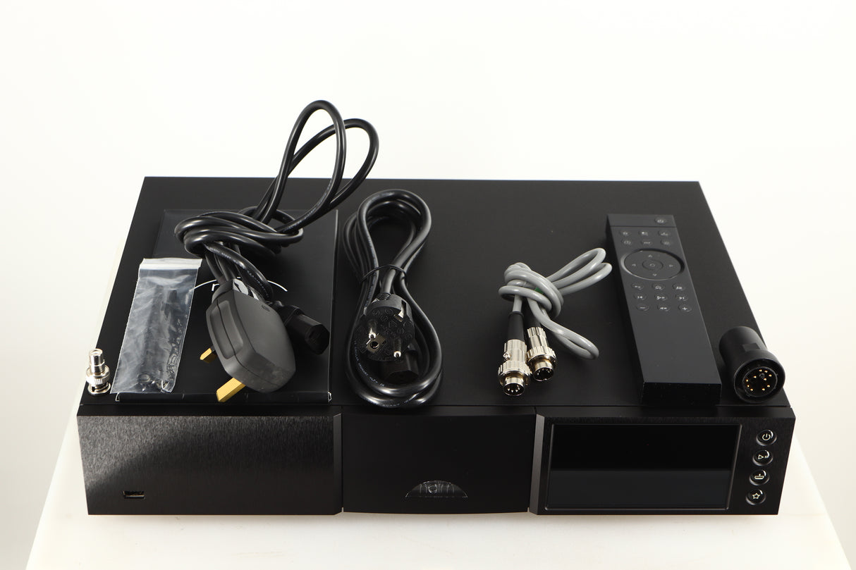 Top of a used Naim NDX2 Network Streamer in a black finish showing Manual, Remote, Batteries, Mains Cable, Schuko Cable, SNAIC5, Link Plug, BNC Adaptor, Bluetooth Antenna and Wi-Fi Antenna
