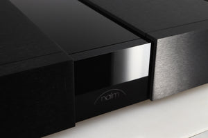 Close up of a used Naim NPX300 Power Supply in a black finish showing a light scratch on fascia