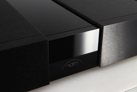 Close up of a used Naim NPX300 Power Supply in a black finish showing a light scratch on fascia