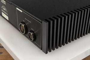 Rear left corner of a used Naim NPX300 Power Supply in a black finish