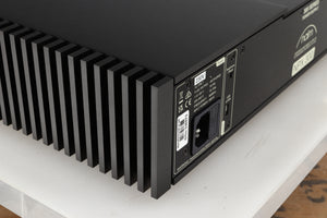 Rear right corner of a used Naim NPX300 Power Supply in a black finish