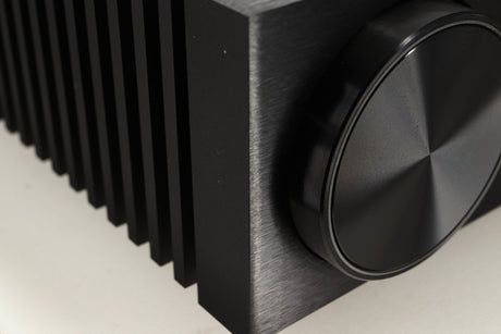 Close up of a used Naim NSC 222 Streaming Pre Amplifier in a black finish showing light scratch near front control knob