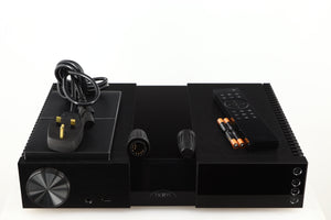 Top of a used Naim NSC222 Pre Amplifier in a black finish showing Mains Cable, Manual, Remote, Batteries and Burndy Plugs