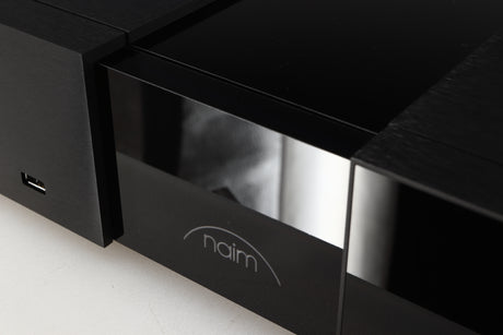 Close up of a used Naim NSC222 Pre Amplifier in a black finish showing scratching on fascia